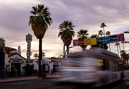 Long Exposure Street Photography Image with Bus and of Palm Trees and Theatre on Palm Canyon in Palm Springs, California